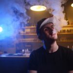 the-man-smoke-an-electronic-cigarette-at-the-vape-2022-01-17-16-24-29-utc